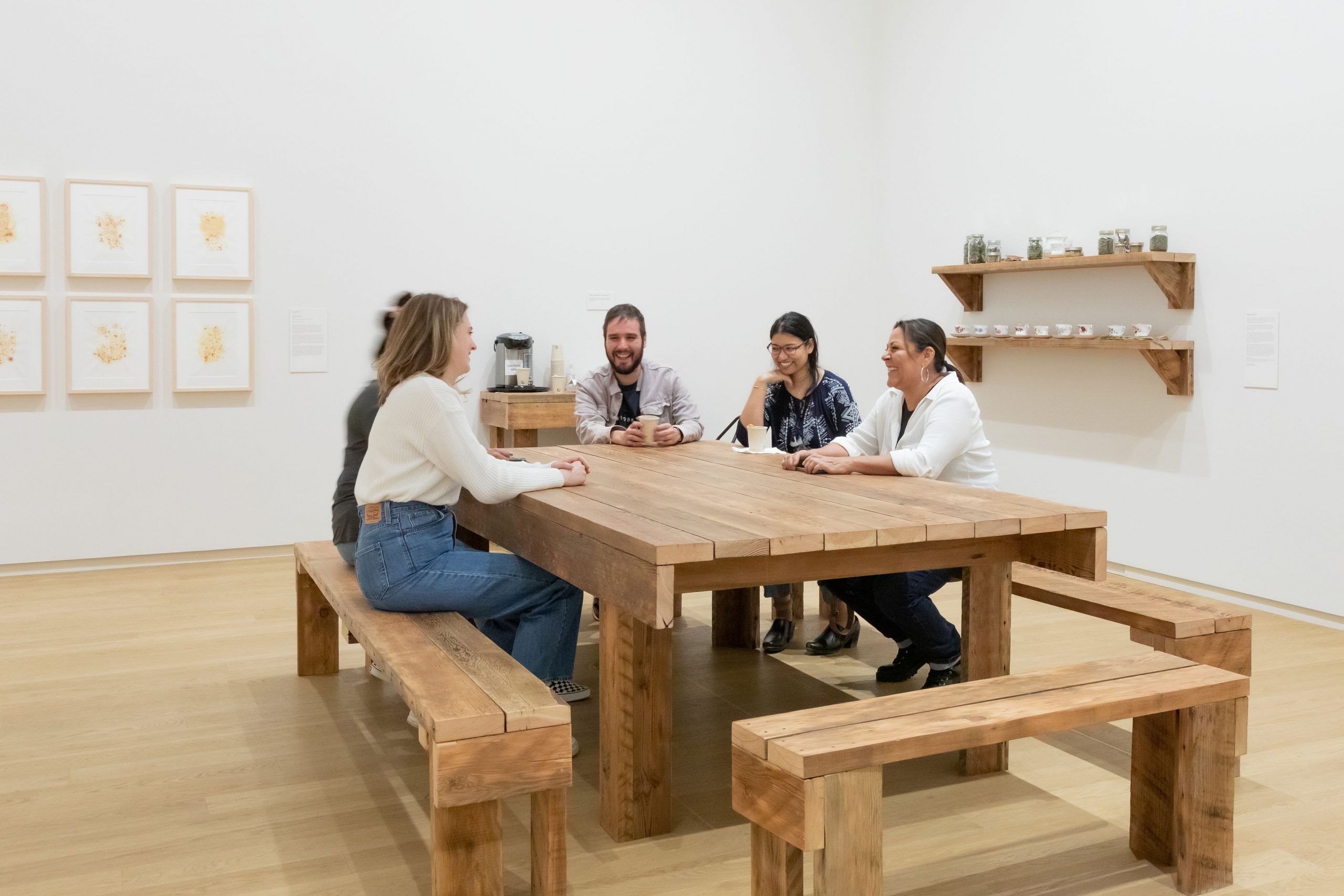 5 people sitting around a table sharing stories