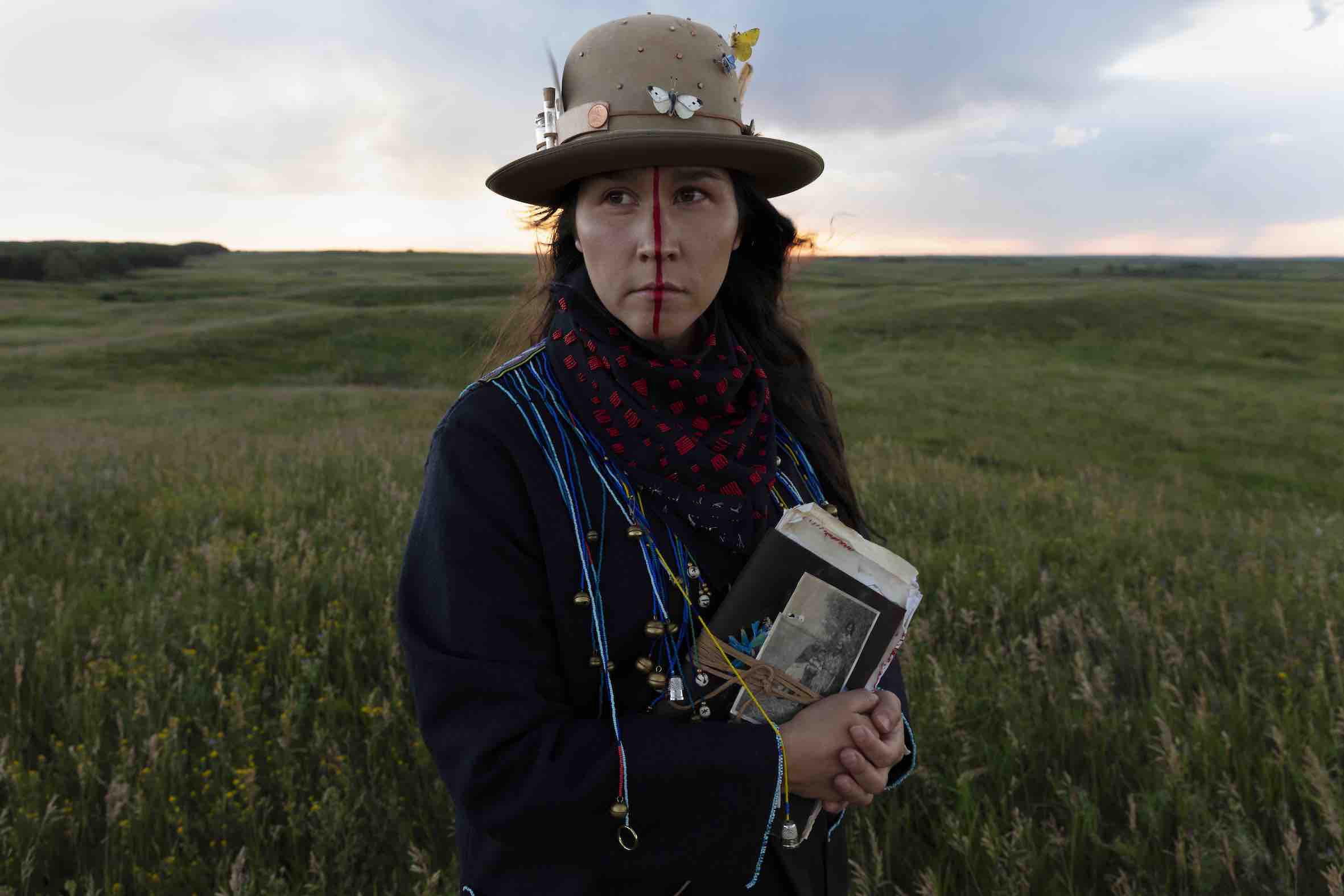 Portrait of a person standing in a prairie field