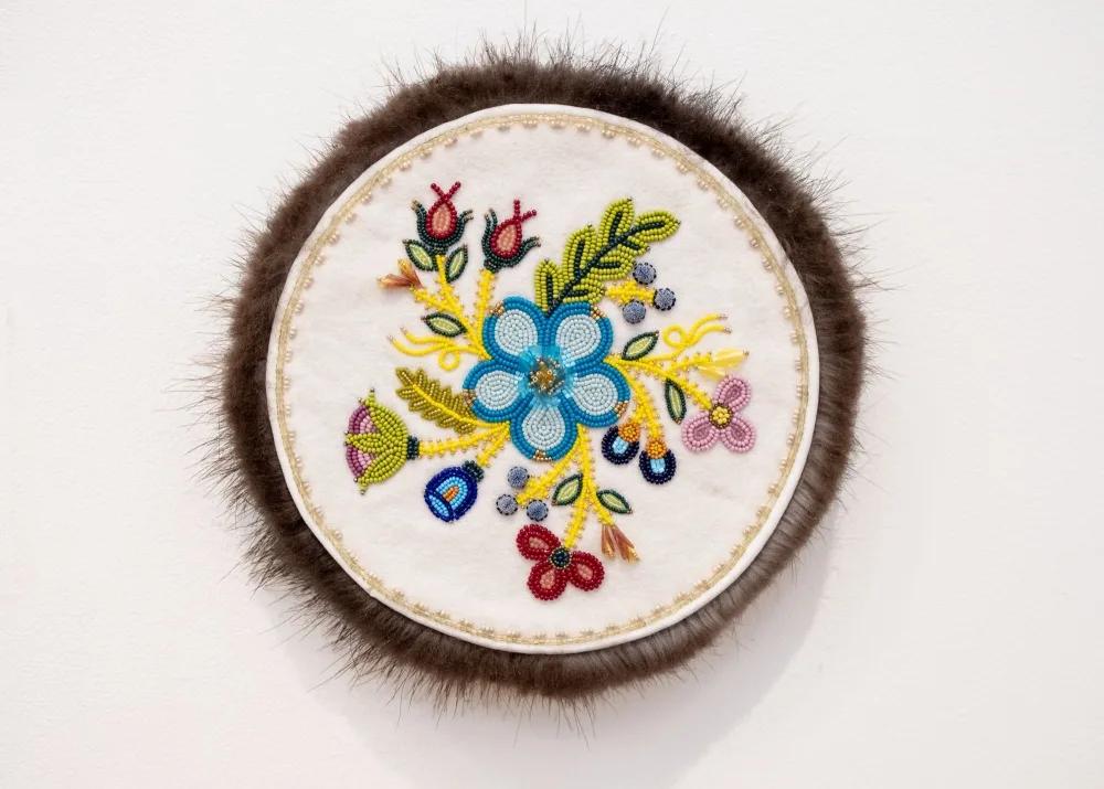 A beaded circular artwork