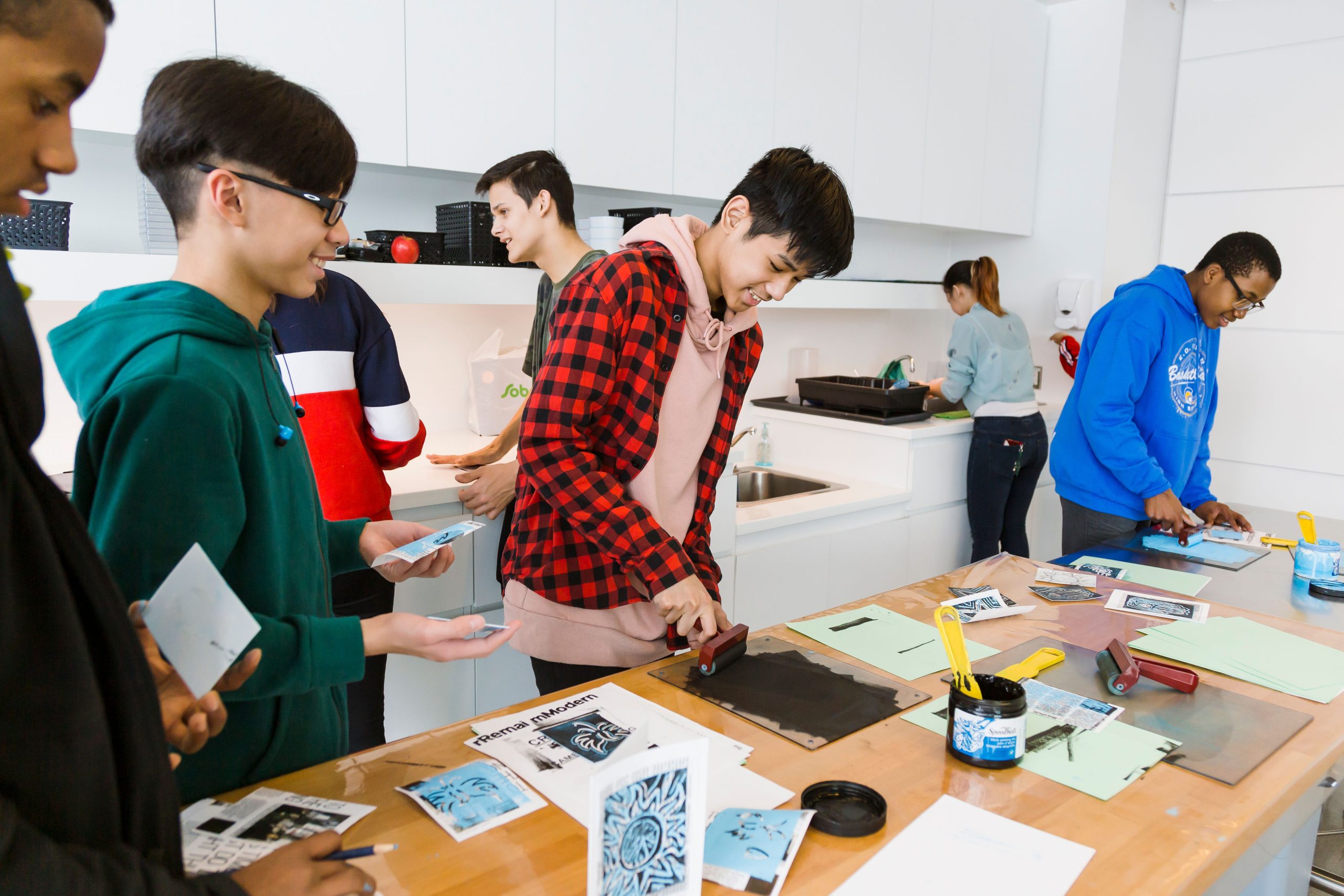 Teens work together on a printmaking activity in Remai Modern's learning studio.