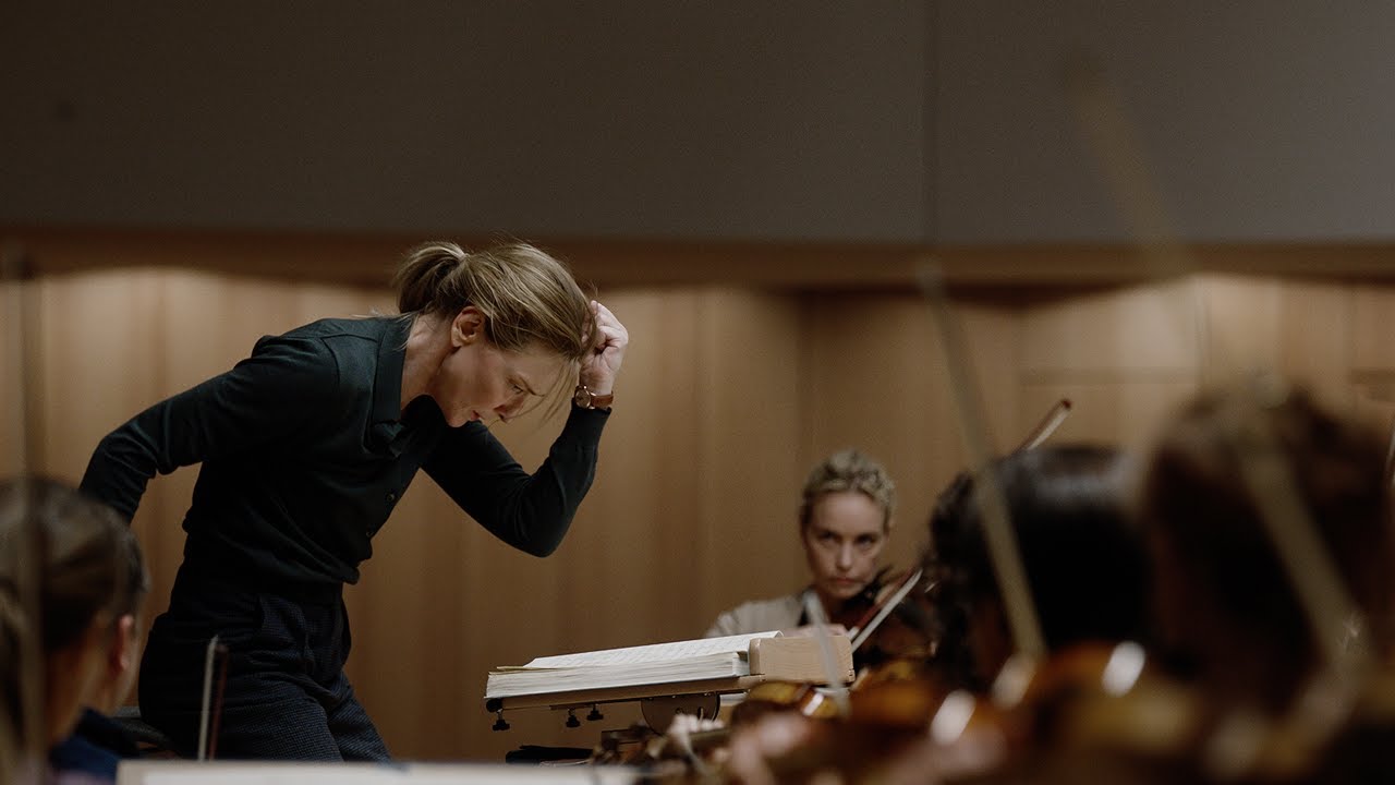 "A conductor intensely leading an orchestra, with a focused expression and one arm raised."