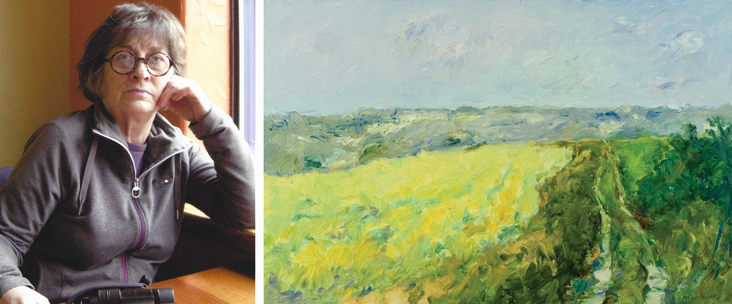 A split image: on the left, a woman with short gray hair and round glasses sits indoors by a window, resting her head on her hand and wearing a dark zip-up jacket. On the right, a colorful impressionist-style landscape painting depicts a bright yellow-green field, a path cutting through greenery, and a hazy blue sky above.