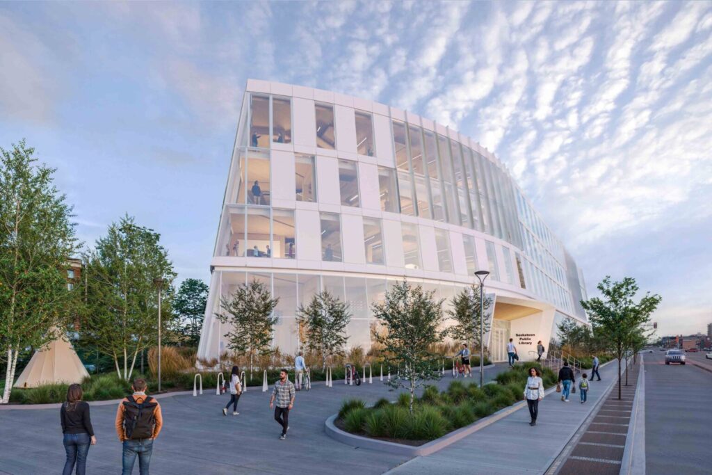 Architectural rendering of a modern, curved white building with large glass windows across multiple floors. The building appears to be a library with 'Saskatchewan Central Library' visible on signage. People are walking around the landscaped plaza area with trees, planters, and pathways.